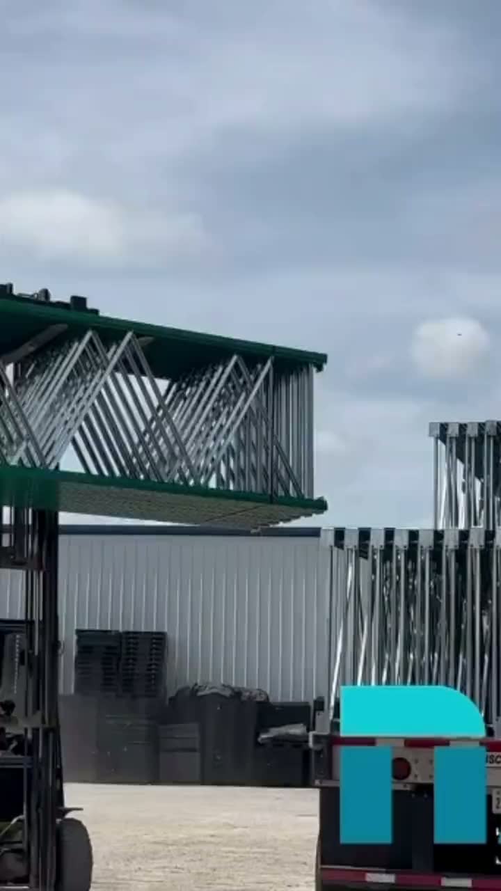 NAWL warehouse with green upright frames and orange teardrop pallet rack beams