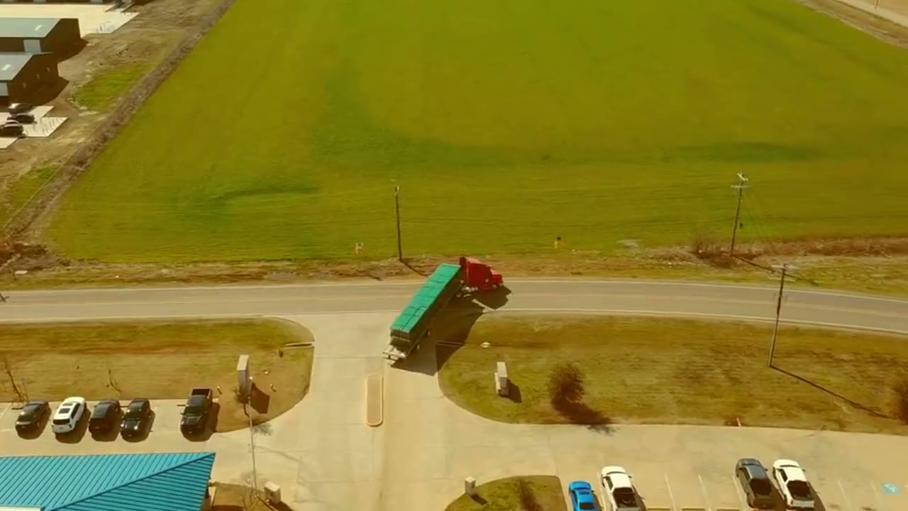 NAWL warehouse with green upright frames and orange teardrop pallet rack beams